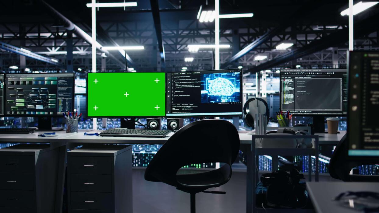 machine learning code on screen - AI development workstations in data center with green screen ...